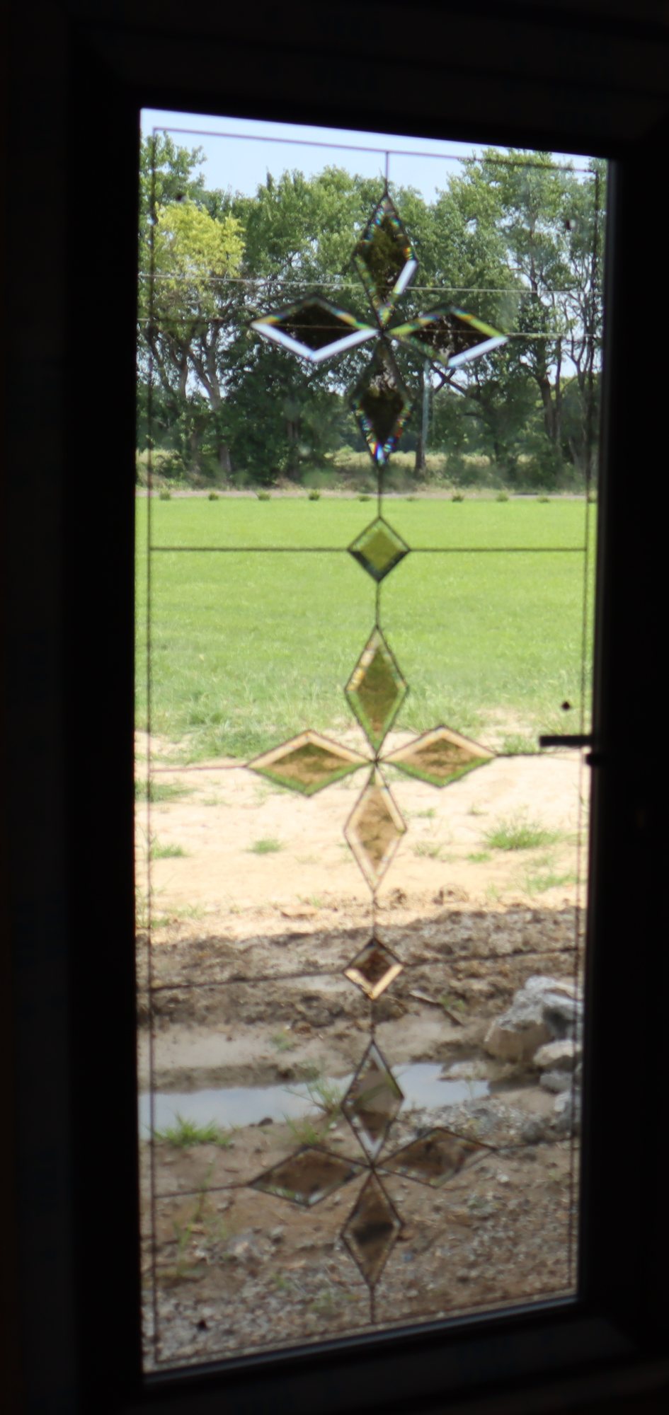Beveled decorative glass panel in an installed entry door